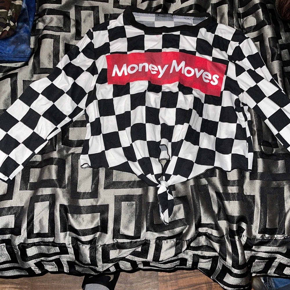 White and black checkered pattern, red and white writing “money moves”